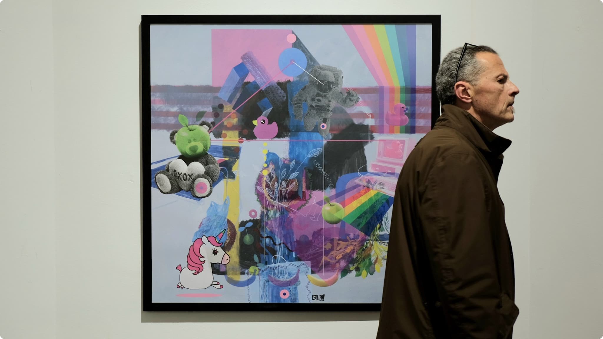 A person passing in front of one of Zoran's paintinigs